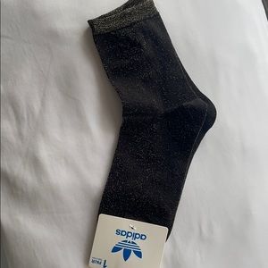 Black Adidas socks with gold specs.